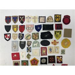 Approximately one-hundred printed and embroidered cloth badges including I, II, VIII, XI, XII and XXX Corps, Eastern Command, various Armoured Divisions, Midland, Wessex, Home Counties and 12th Infantry Brigades, Salisbury Plain, Northumberland, Hampshire, North Midland, West Riding, Essex and Suffolk Districts, Berlin & Rhine Army Troops etc