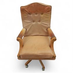 Late 20th century swivel executive desk chair, upholstered in tan leather with brass studded trim, raised on five point base raised on castors 
