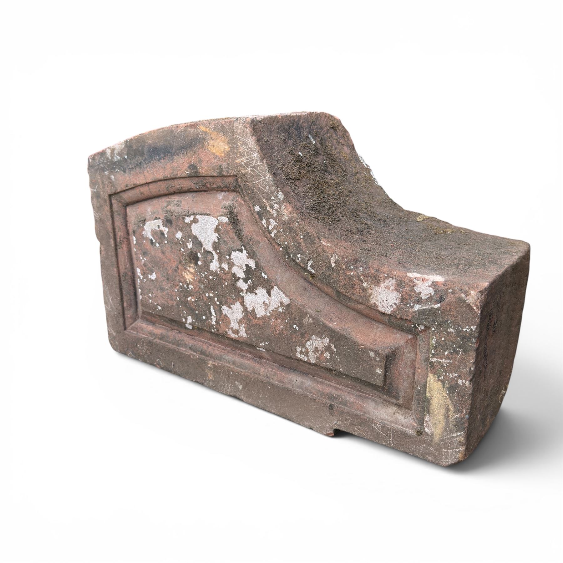 Pair of 19th century hewn and carved stone wall ends, the facias carved as shaped faux fielded panels