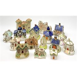 A collection of various 19th century Staffordshire pastille burners modelled in the form of buildings, together with other models of buildings, a number of later similar examples, plus an early 19th century Prattware money box, (a/f). (16). 