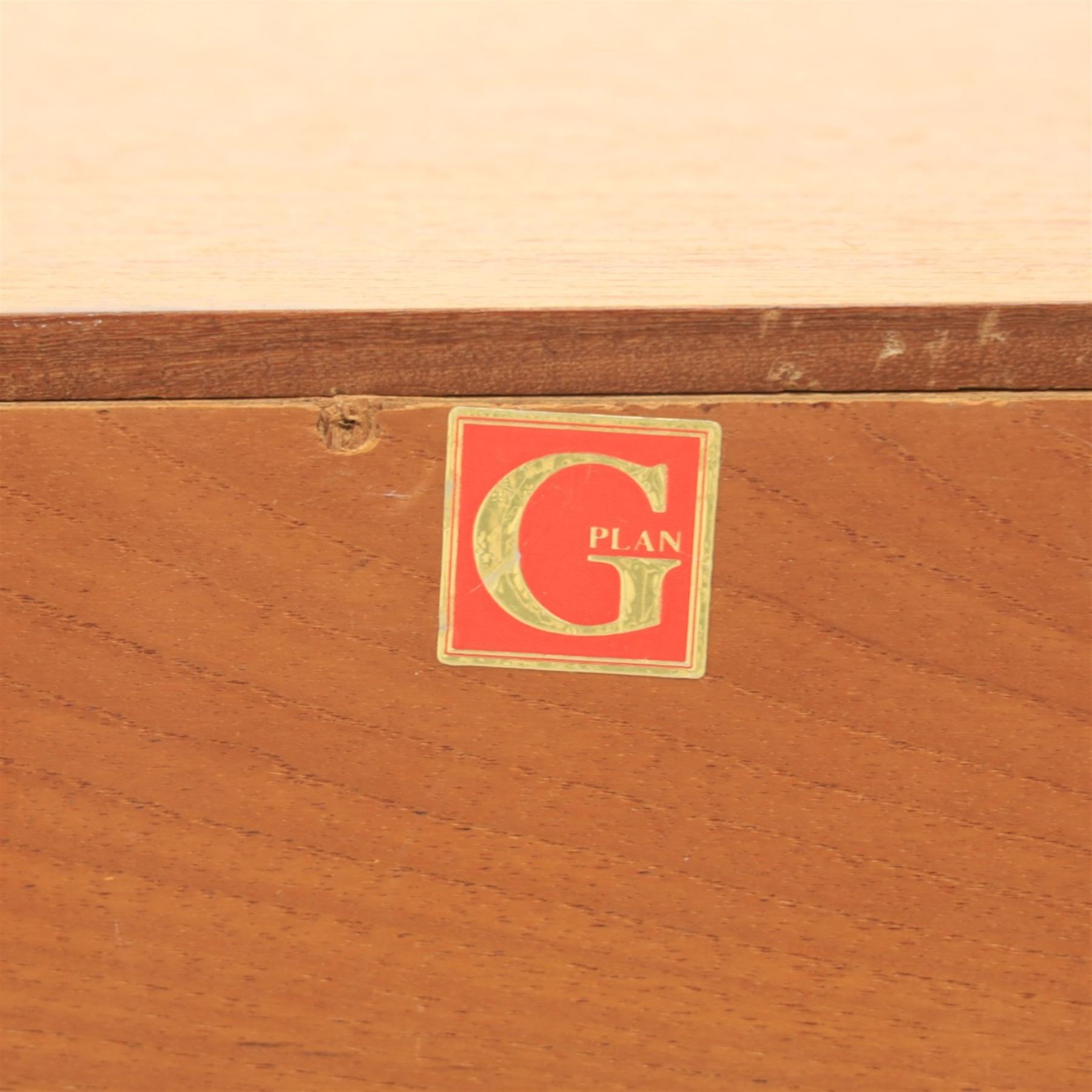 G-Plan - teak corner media unit, shaped top above a sliding central shelf above an open recess, flanked by further shelves, raised on a plinth base with a rear aperture for wires