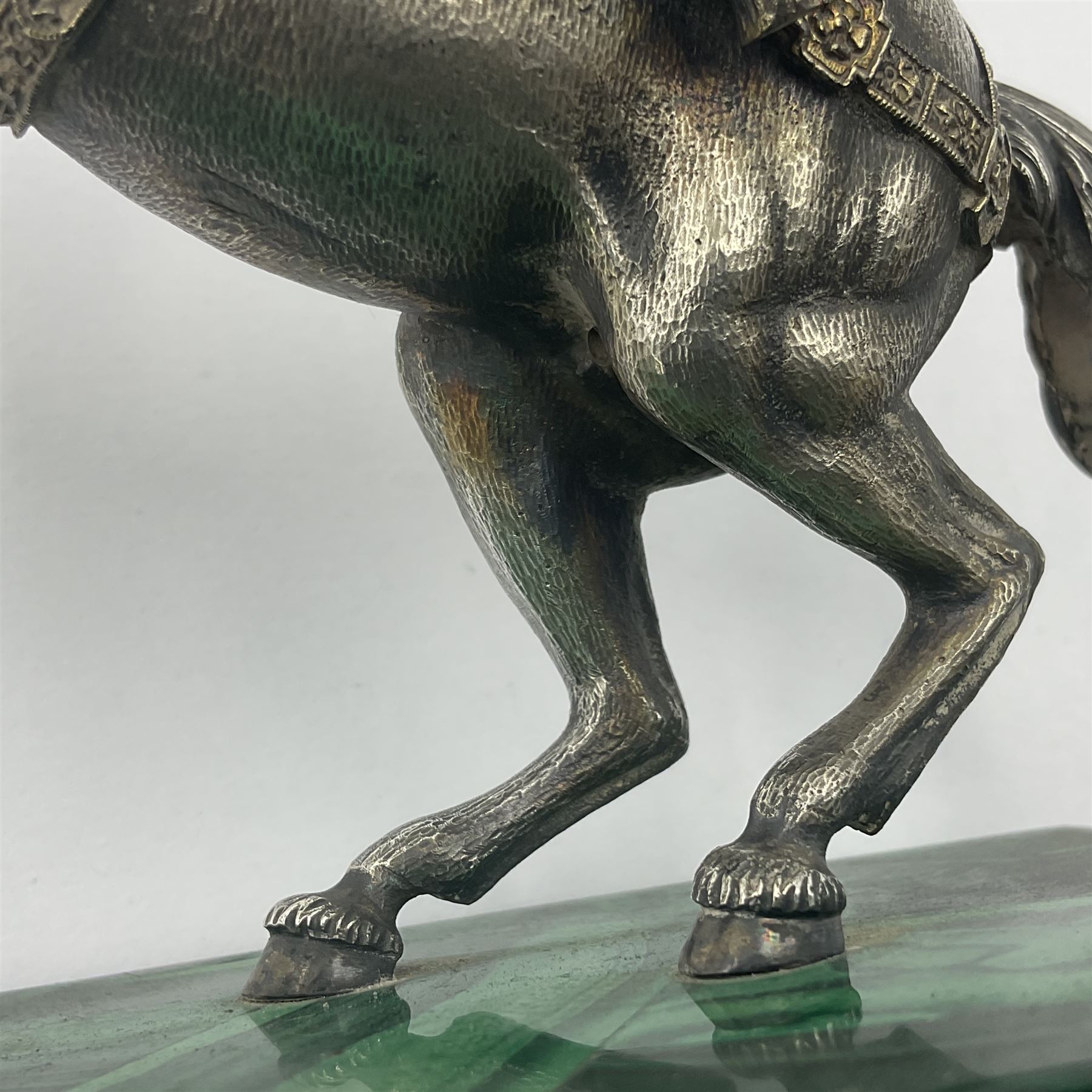 Modern silver model of a rearing horse, with ornate parcel gilt saddle and bridle, mounted upon a rectangular base, decorated with malachite panels to each side and upon four gilt bun feet, horse stamped 925, overall H14.5cm