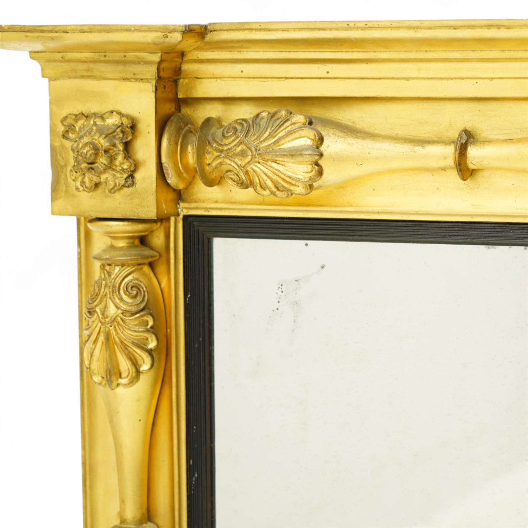 Early 19th century Regency giltwood and gesso overmantel mirror, rectangular plate within a black inner border, form with stepped cornice above a frieze carved with shell and foliate motifs, flanked by swell turned fluted pilasters with applied anthemion decoration