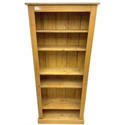 Contemporary pine open bookcase, fitted with five adjustable shelves, skirted base