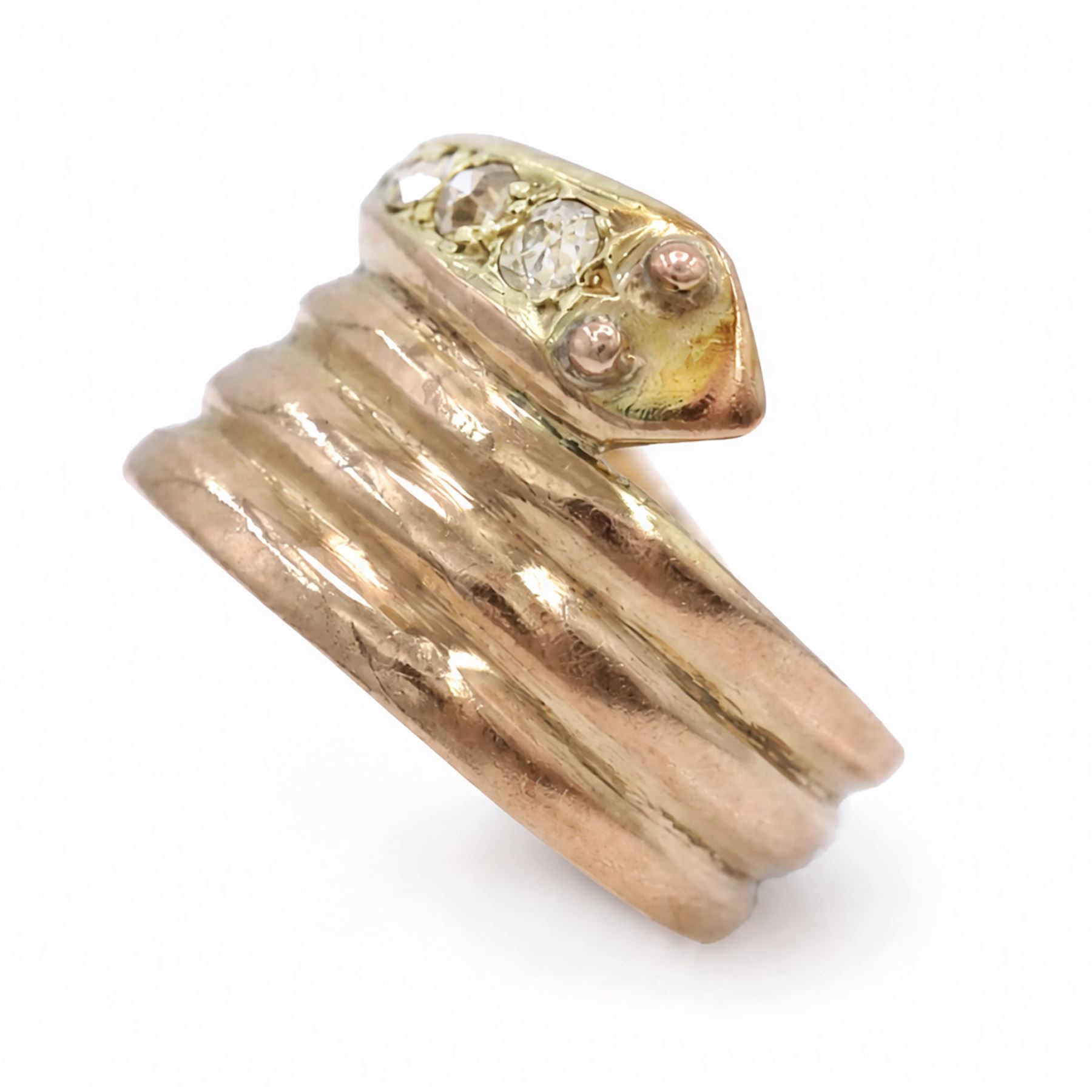 19th / early 20th century 9ct gold diamond coiled snake ring, the head set with four graduating old cut diamonds