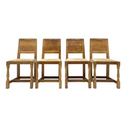 'Eagleman' set four oak dining chairs, adzed panelled backs, upholstered seats with stud work band, the side rails relief carved with inset eagle signature, shaped octagonal supports joined by stretchers, by Albert Jeffray of Sessay, Thirsk
