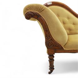 Victorian walnut chaise longue, carved with scrolling acanthus to the end supports and seat rail, upholstered in mustard coloured velvet, shaped and buttoned back and side with turned spindle gallery, raised on short turned legs with ceramic castors 
