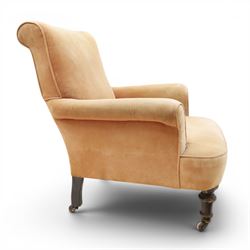Victorian mahogany framed armchair of traditional shape, the high sprung rolled back over out-swept arms, deep sprung seat over turned feet with ceramic castors, upholstered in pale salmon pink fabric
