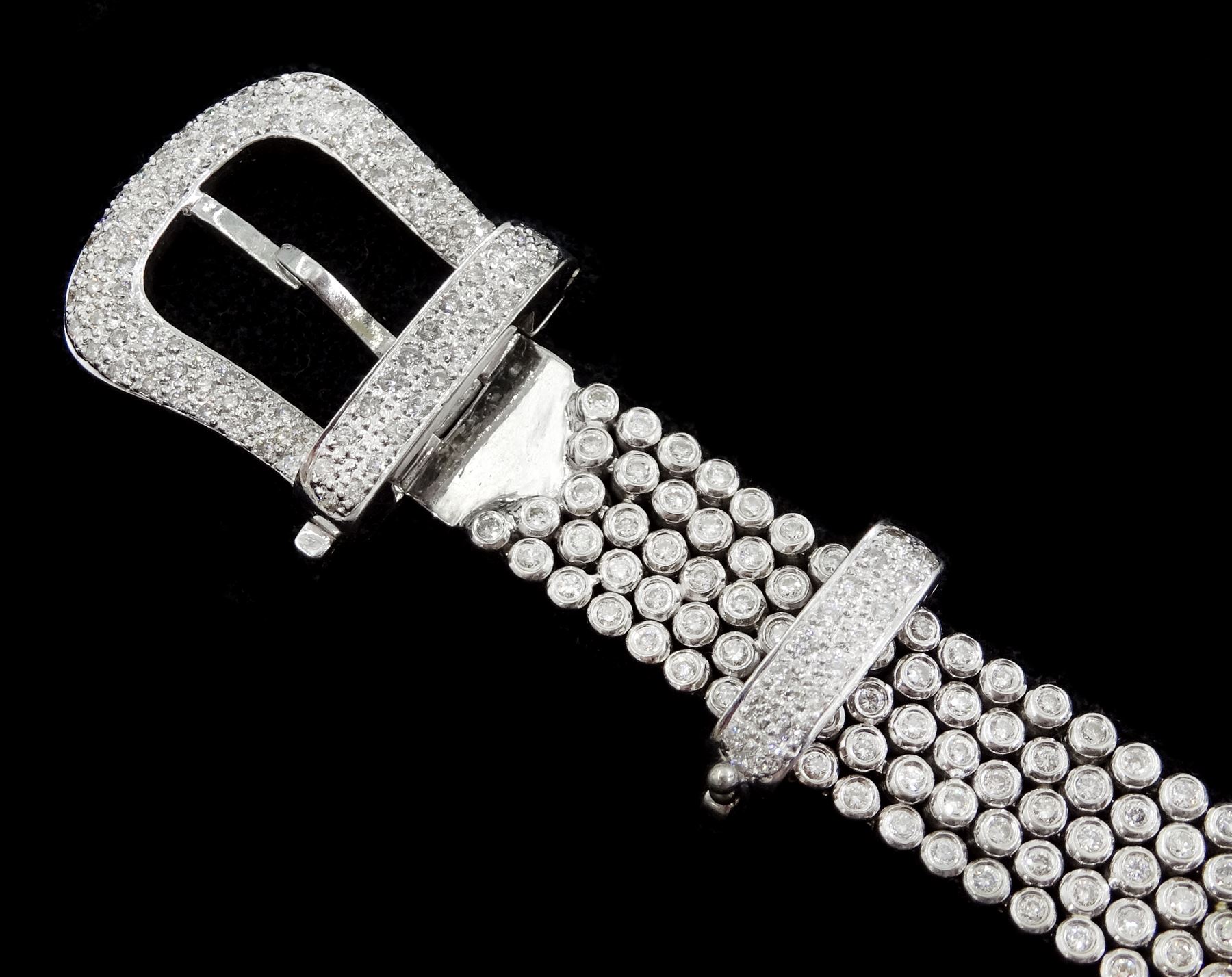 14ct white round brilliant cut diamond belt bracelet, the bracelet with rubover set diamonds, the buckle and clasp with pave set diamonds, stamped 14K, total diamond weight 5.35 carat