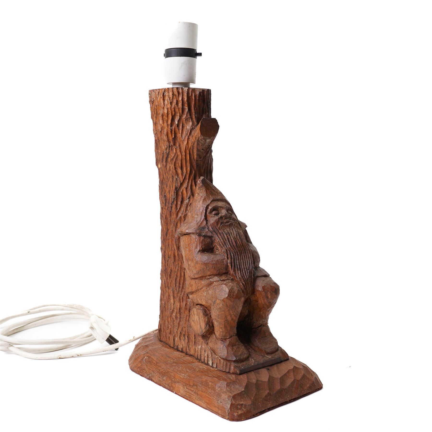 Gnomeman - an oak table lamp, with carved gnome figure seated on a log at the base of a tree stump, on a tooled base, by Thomas Whittaker of Littlebeck, H28cm excluding fitting