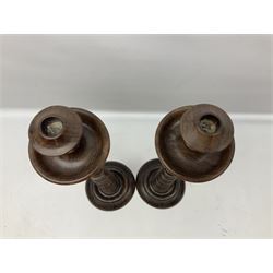 Pair of turned wooden candlesticks, the central column of stepped form raised upon circular spreading base, with drip trays, H56cm