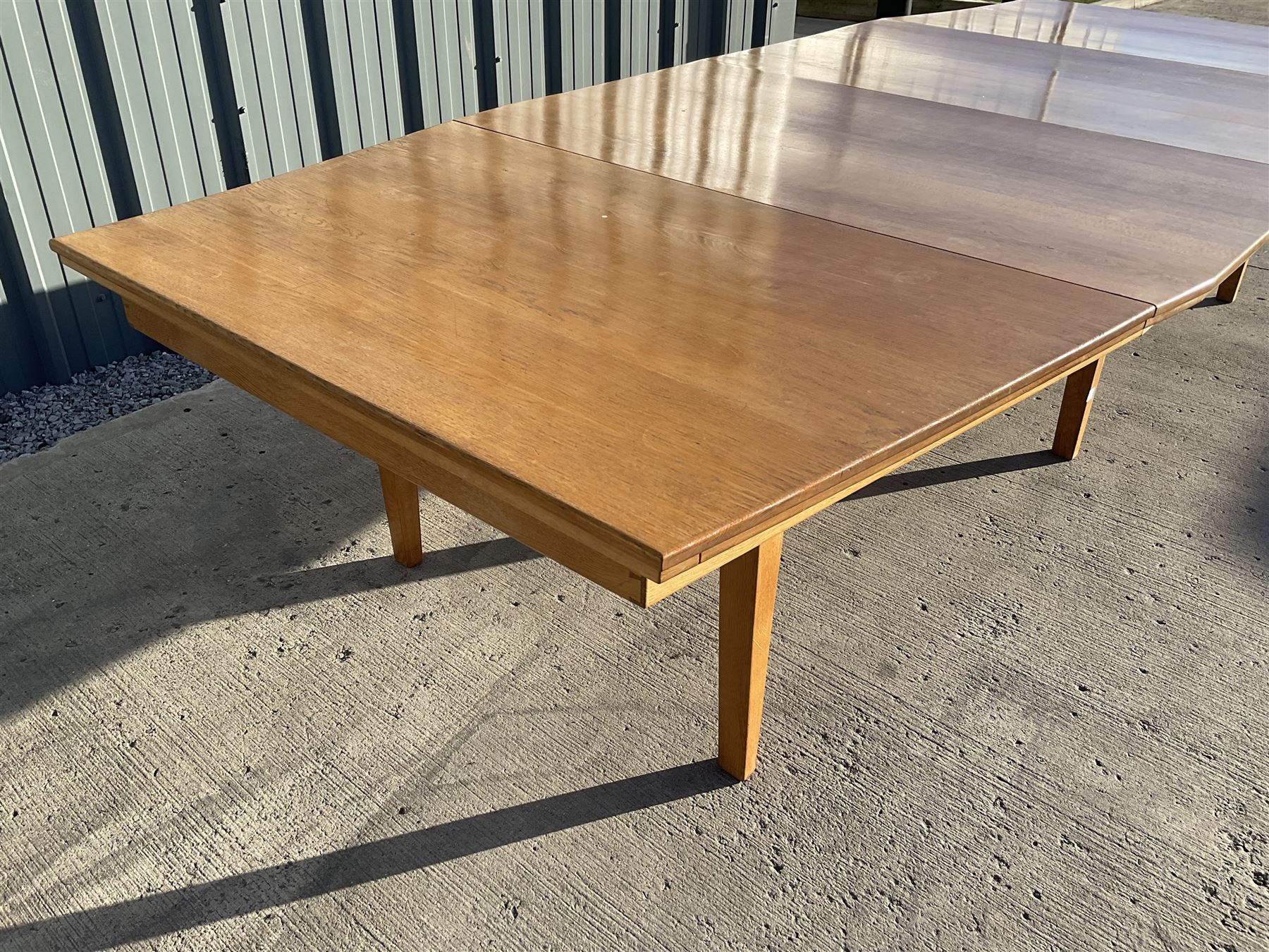 Light oak bespoke boardroom table, concave form, four sectional top on square discreet legs (12' x 5'), with twelve armchairs including 'Chairmans' chair