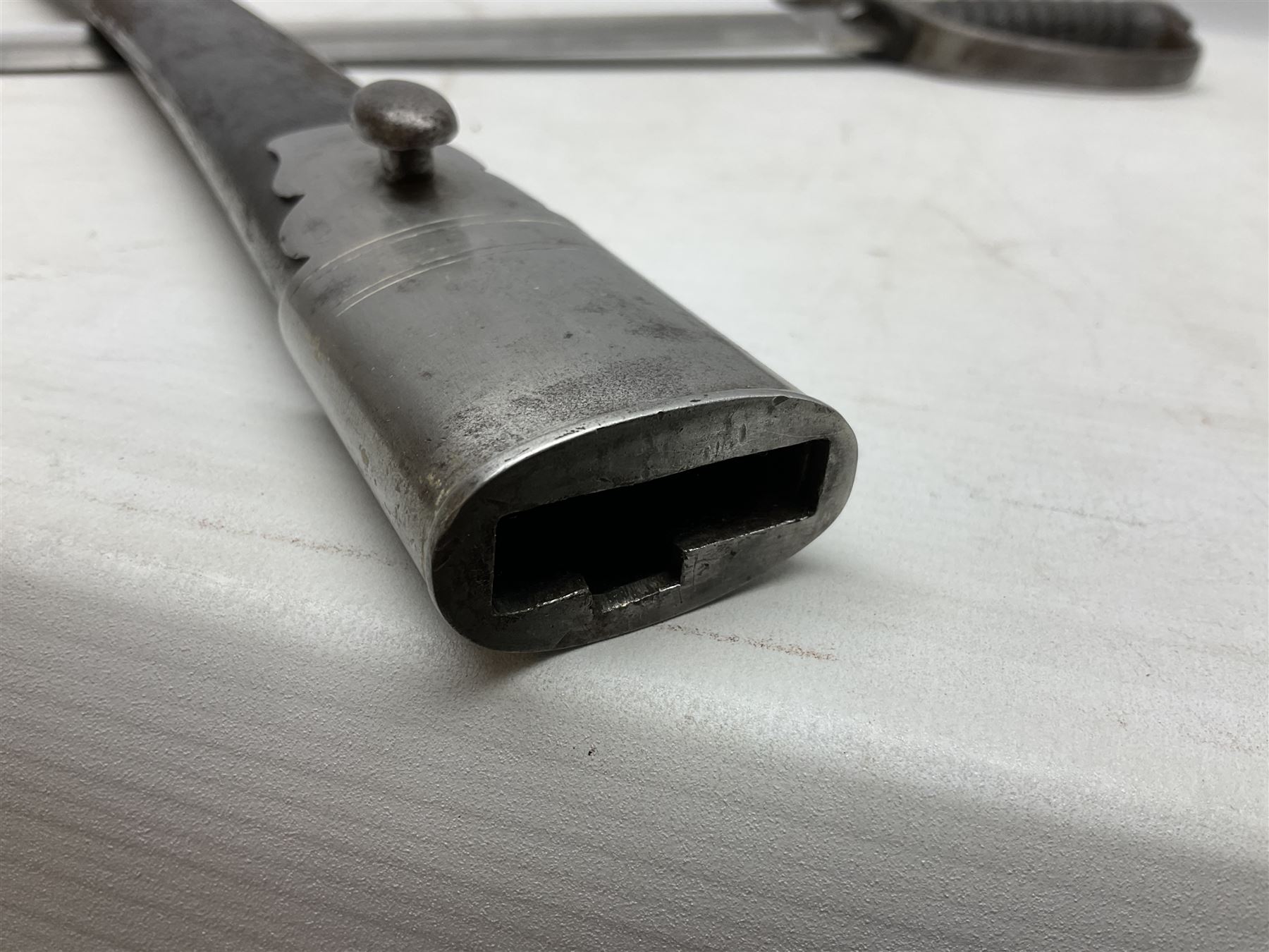 Mid-19th century Custom’s officer/Constabulary sidearm, with plain 60.5cm slightly curving fullered blade double edged at tip,  steel knucklebow and downswept quillon, stepped pommel and ribbed fishskin grip; in leather covered scabbard with steel locket, frog stud and chape L76cm overall