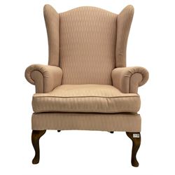 20th century walnut framed wingback armchair, upholstered in pink fabric with squab cushion, raised on cabriole front supports
