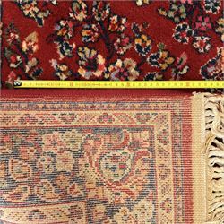 Persian Isfahan-style hand-knotted rug, crimson ground, with an intricated all-over floral spray design with palmettes and leaves, wide midnight blue main border with rosette and palmette motif, flanked by narrow guard borders  