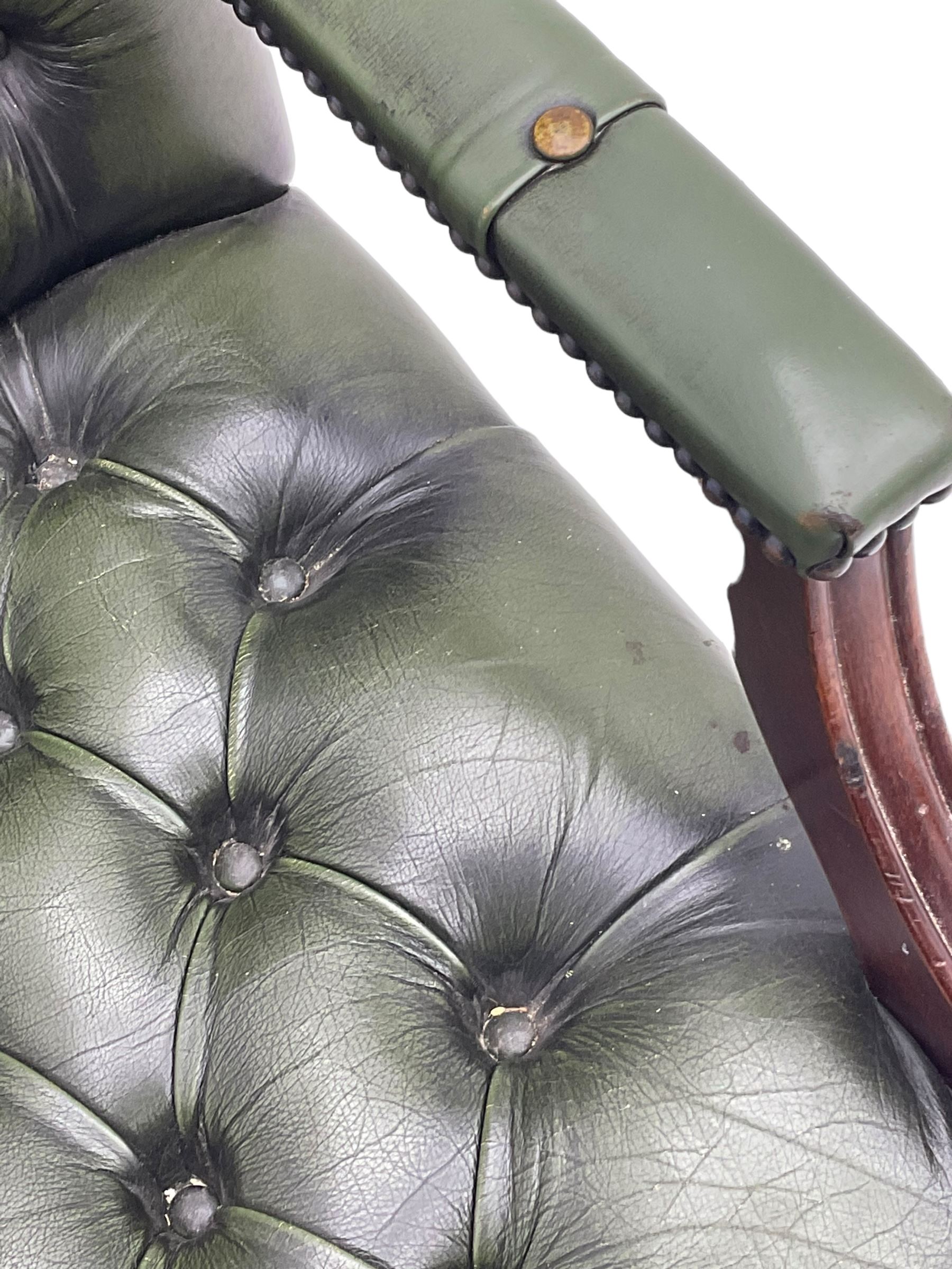 Georgian design swivel office desk chair, upholstered in buttoned green leather, on five spoke base with castors 