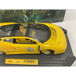 Two Maisto 1:12 scale Jaguar XJ220 ‘Racing’ cars in yellow, both on plinths in original boxes 