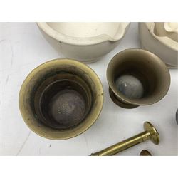 Group of pestle and mortars to include heavy bronze example with twin handles, cream stoneware Wedgwood example,  brass examples etc