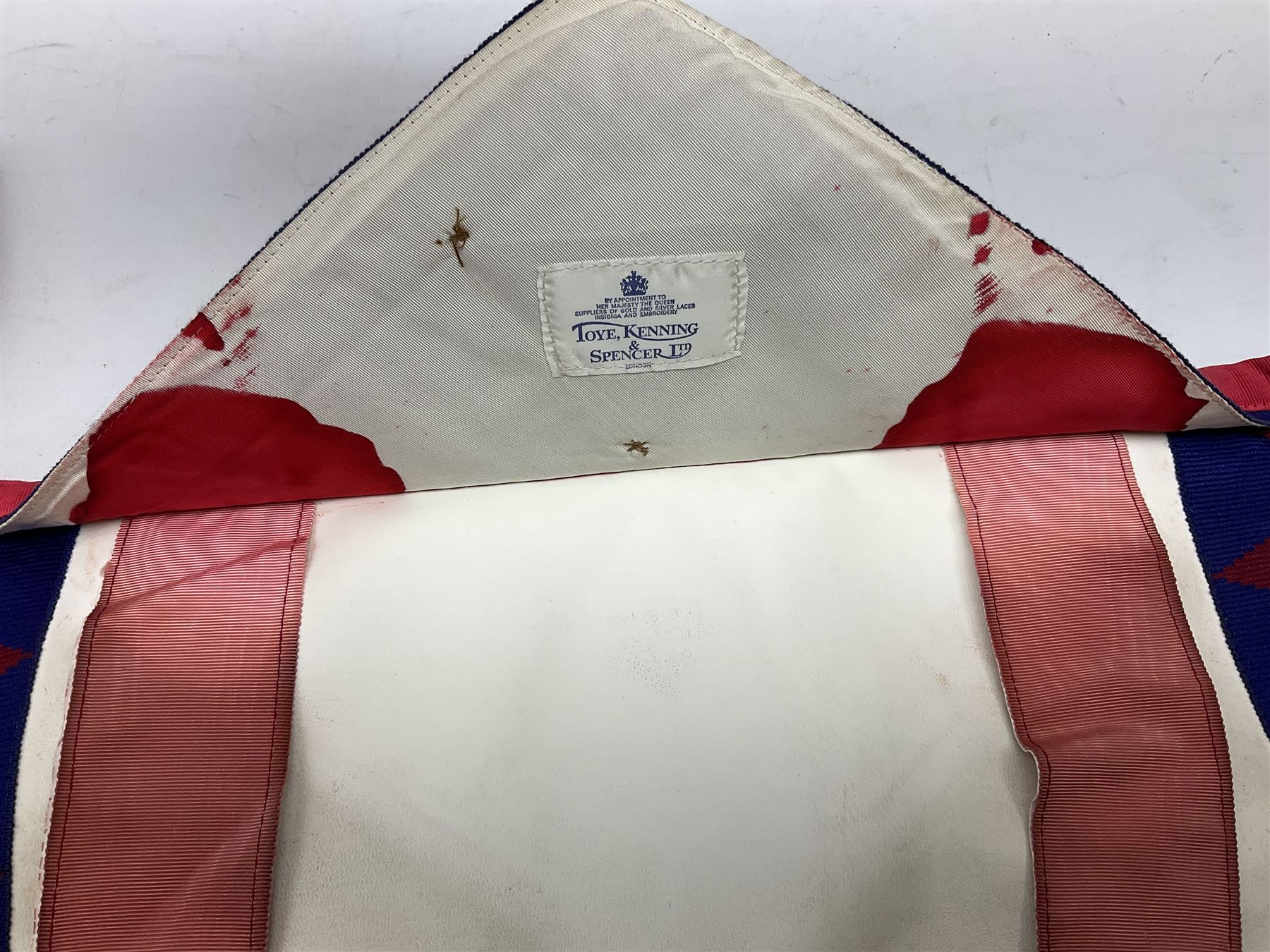Two Masonic kid leather aprons, one with sash and cuffs, the other with sash, each marked 'Yorkshire North and East Ridings'; and three other unmarked Masonic aprons with sashes