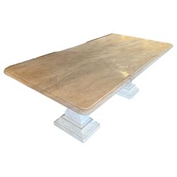 Classical Grecian design Carrera marble centre table, the rectangular single slab top with rounded corners and carved edge, raised on twin pedestals comprised of three pieces with a waisted column on a stepped plinth