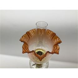 Victorian brass oil lamp, the square stepped base leading to a Corinthian column supporting a part slice cut clear glass reservoir, burner, clear glass chimney and foliate etched glass shade with amber rim, overall H80cm