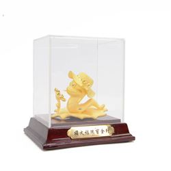 24ct gold model of a snake wearing a hat on a leaf with a sunflower, within a display case...