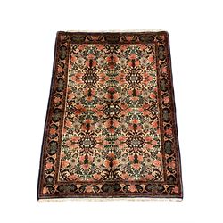 Persian Zanjan rug, pale ground and decorated with floral Herati motifs, decorated all over with flower heads, repeating scrolled guarded border