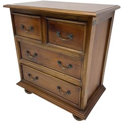20th century hardwood chest, fitted with two short over two long drawers with moulded facias, lower moulded edge over large bun feet