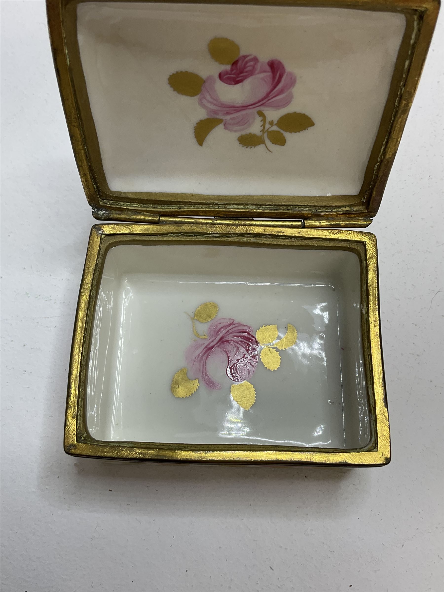 Early 19th century Swansea box of rectangular form, densely decorated with painted pink cabbage roses and gilt foliage upon plain ground, the hinged lid opening to reveal interior painted with two further roses upon plain ground, marked Swansea. in gilded lettering beneath, W7cm H3.5cm D5.5cm
