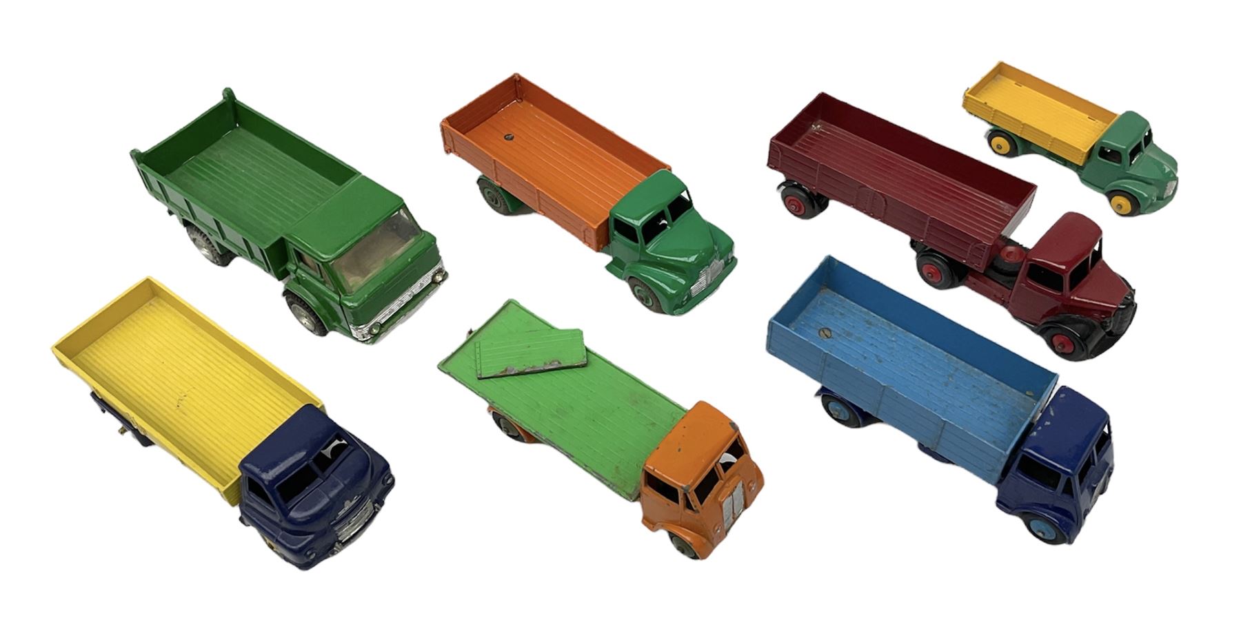 Dinky - seven unboxed and playworn/repainted die-cast commercial vehicles comprising Bedford Articulated lorry, Leyland Comet, Big Bedford, Ford 800 tipper truck, Guy flatbed and planked flatbed lorries and Dodge tipper truck (7)