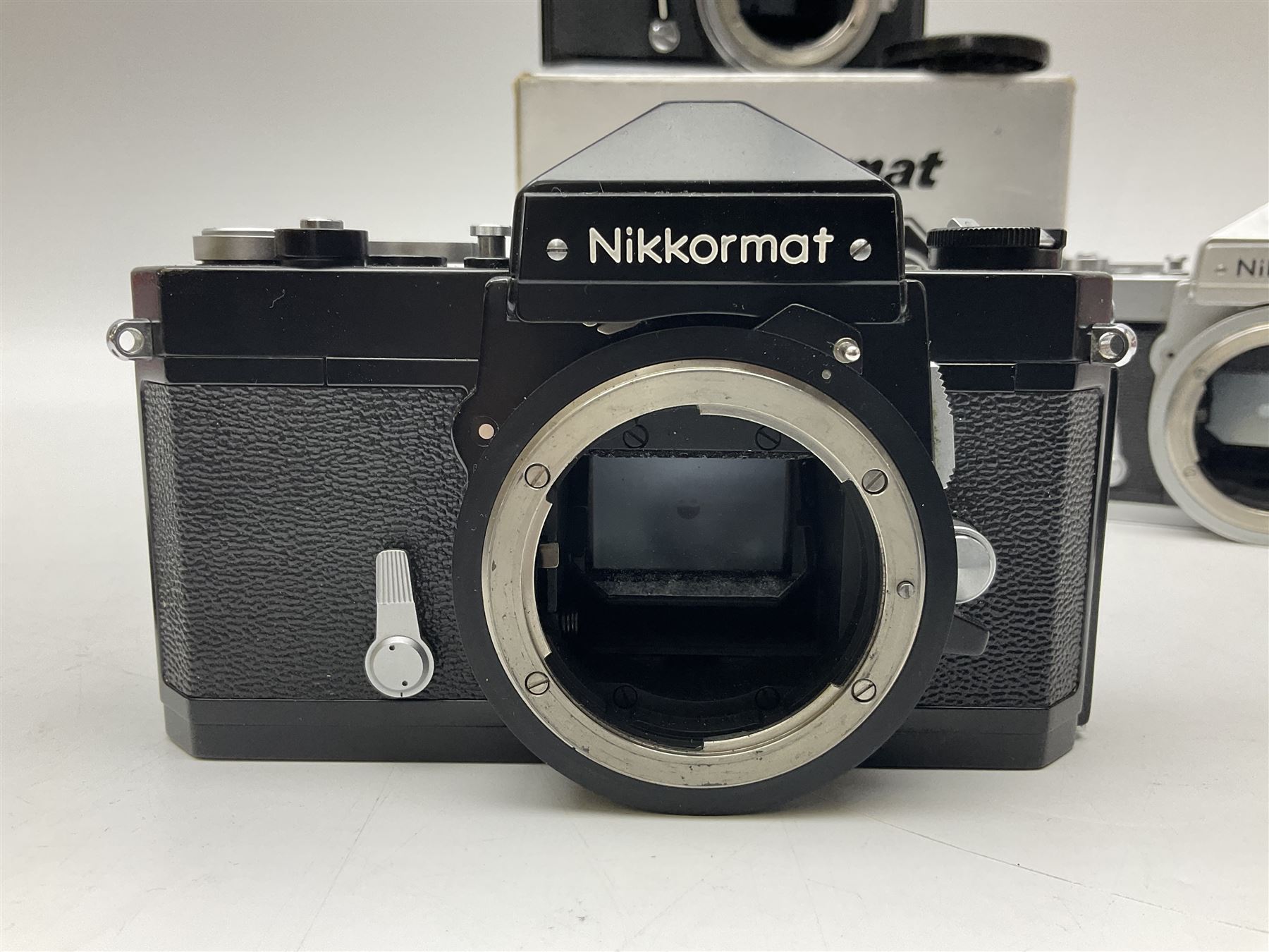 Nikkormat FT2 camera body, serial no. 5066813, in original packaging, together with Nikkormat EL camera body, serial no. 5577358, with Nikon Nikkor 50mm 1:1.8' lens no. 2143575, Nikkormat FT, serial no. 3968385, and Nikomat FT camera body, serial no. 4015491