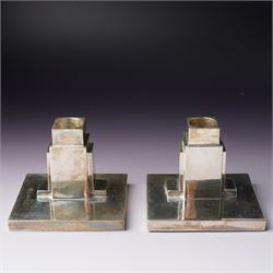 Pair of Art Deco silver candlesticks with square section stems supported by two lappets on a rectangular base H7.5cm x W9.5cm Sheffield 1935 Maker Walker & Hall