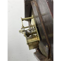 Mid-19th century mahogany veneered eight-day four-pillar single fusee drop dial wall clock with an octagonal dial surround and scroll brass inlay, circular painted steel dial with roman numerals and minute track, matching trefoil steel hands, brass bezel with a flat glass, curved trunk with brass inlaid circles and stringing around the glass pendulum aperture with a brass slip, carved ear pieces in the form of flowers and leaves, with pendulum adjustment door and movement door. With Pendulum & Key