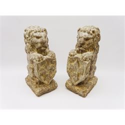 Pair 20th century composition stone heraldic lions, each modelled with forelegs supporting shield detail with fleur-de-lis, upon rectangular base