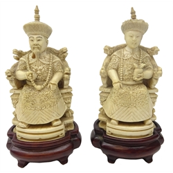  Pair 19th century Chinese ivory figures of an Emperor and Empress seated on thrones, carved with Dragons and Phoenix on shaped hardwood bases, signature to base, H24cm excluding base   