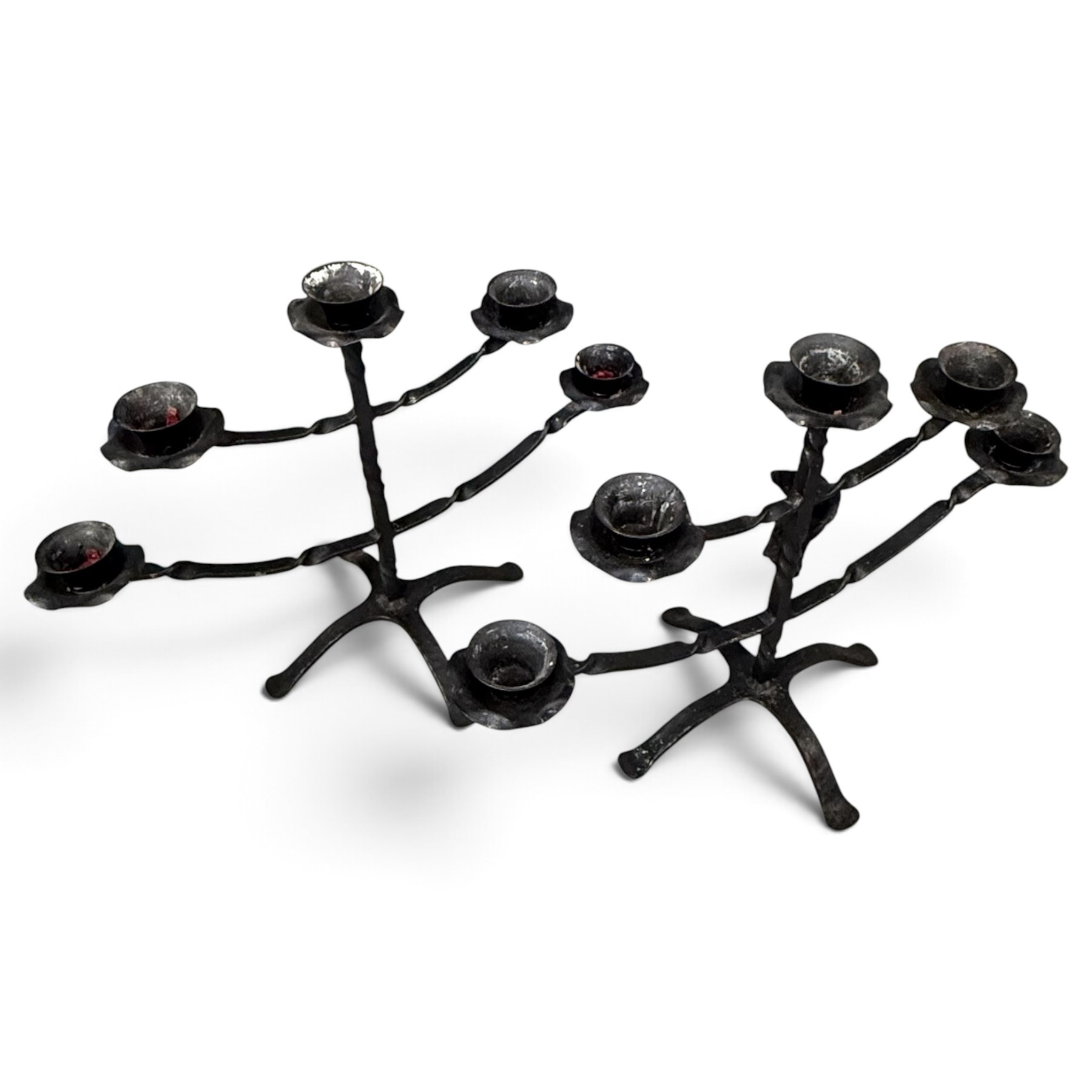 Collection of wrought iron candle stands, comprising five-light and three-light floor-standing candelabra with scrolling branches, and a pair of five-light table candelabra of naturalistic branching form