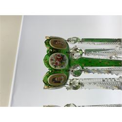 Pair of 19th century Bohemian green glass lustres, the castellated bowls decorated with overlaid panels of flowers and female portraits, upon tapering stems and overlaid spreading feet, heightened throughout with gilt, each supporting ten prismatic drops, H35cm