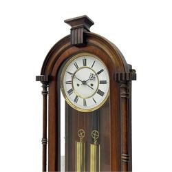 Lenzkirch – 8-day walnut cased weight driven Vienna regulator manufactured 1877-1878, with a break-arch pediment surmounted by a turned finial on a raised cavetto molding, fully glazed arched  door flanked by long ring turned pendants, flat base with open fretwork and two short pendants,  two piece enamel dial within a brass slip, Roman numerals, minute track and pierced steel hands, wooden pendulum with a brass faced bob, two brass cased weights and pulleys, dead beat escapement with a rack striking movement sounding the hours and half hours on a coiled gong, movement serial number 421410. 
Lenzkirch were one of Germanys most highly respected clock manufacturers of the 19th century, founded in the late 1850s the company produced movements and cases of high quality up until 1932.
