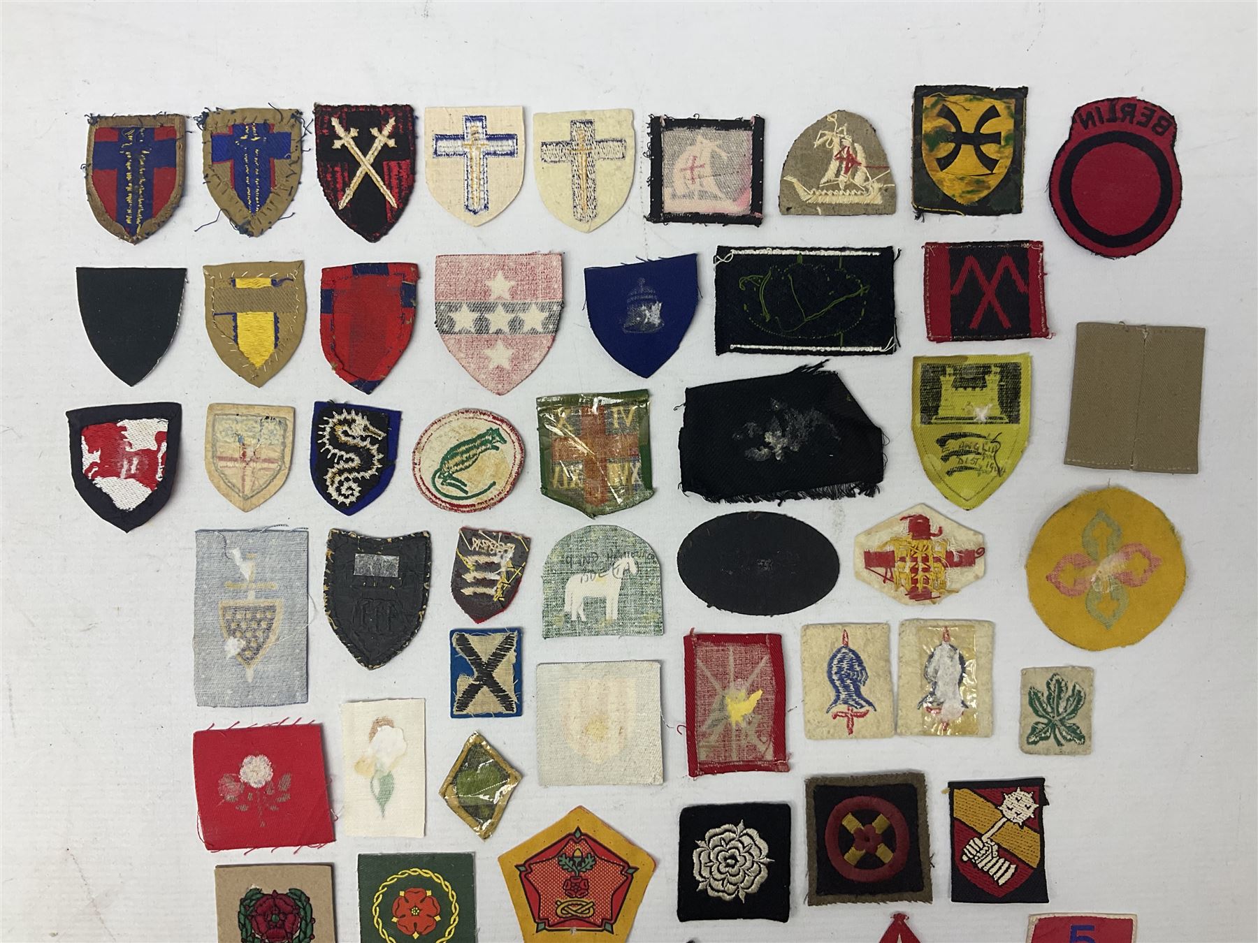 Approximately one-hundred printed and embroidered cloth badges including I, II, VIII, XI, XII and XXX Corps, Eastern Command, various Armoured Divisions, Midland, Wessex, Home Counties and 12th Infantry Brigades, Salisbury Plain, Northumberland, Hampshire, North Midland, West Riding, Essex and Suffolk Districts, Berlin & Rhine Army Troops etc