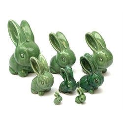 A collection of eight Denby green glazed models of the Rabbits Marmaduke and Cotton tail, various sized, largest H20.5cm, some marked. 