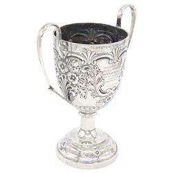 Edwardian silver twin handled trophy, engraved with presentation engraving and embossed with floral and foliate decoration to body, upon a domed circular weighted base, hallmarked 	Hammond, Creake & Co (Saint Arnaud Creake), Sheffield 1902, H22cm