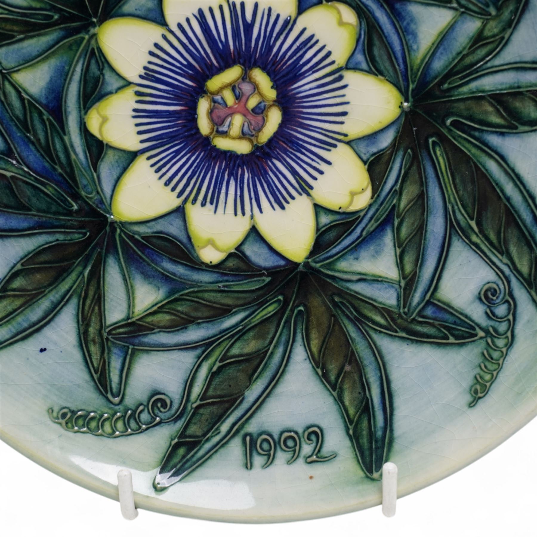 Moorcroft limited edition Birth of Light pattern millennium year plate, numbered 699/2000, impressed and painted marks to base; together with three other year plates comprising 1998, 1992 and Spitalfields Temple Mills edition 1991 plate (4)