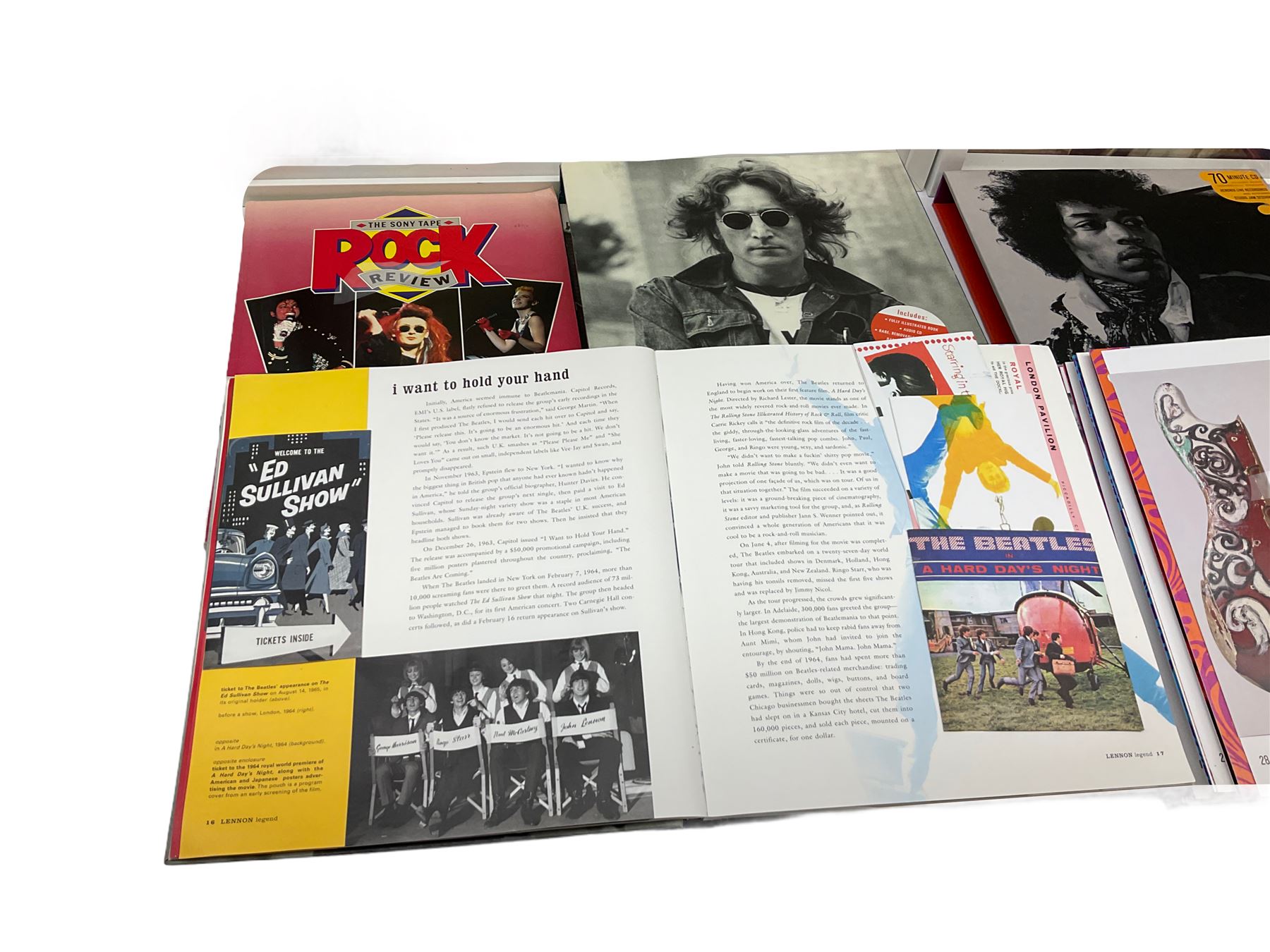 Two novelty framed LP wall clocks; two books containing replica memorabilia and CDs on John Lennon and Jimi Hendrix; Rock Review booklet; and book on Cliff Richard entitled 'Cliff In His Own Words' (6)