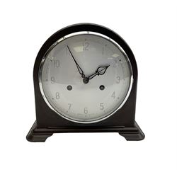 Enfield- English 1950's 8-day mantle clock in a round topped brown Bakelite case on splayed feet, with a glazed chrome bezel and silvered dial with Arabic numerals and original pierced hands, twin train spring driven movement, sounding the hours and half-hours on a coiled gong. With pendulum & key.  