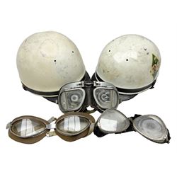 Two Geno Paris small size motorcycle helmets; and three pairs of goggles, one marked 'Stadium'