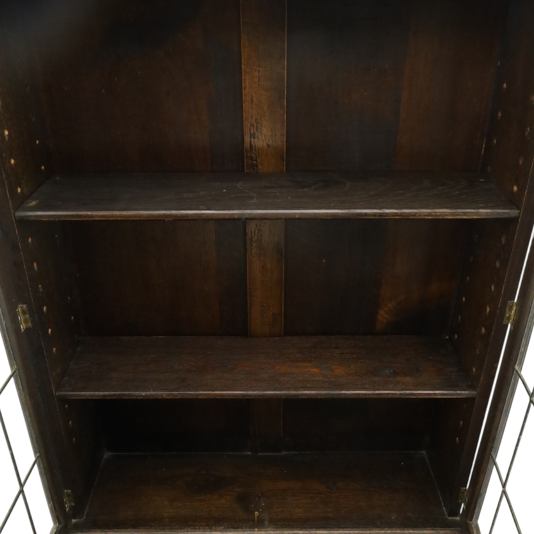 Early 20th century Jacobean Revival oak bureau-bookcase, astragal glazed doors enclosing two adjustable shelves, over geometric panelled fall-front enclosing fitted interior, over two drawers, raised on a spiral-turned base with barley-twist stretchers and compressed bun feet