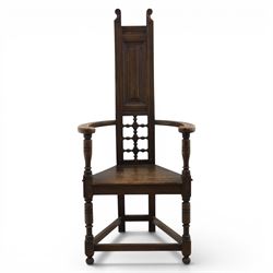 Manner of Liberty & Co. - Arts & Crafts oak Shakespeare chair, high back over triangular seat, flanked by swept arms, raised on turned and block supports united by stretchers