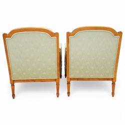 French Empire design varnished wood three piece lounge suite comprising of two cane armchairs and matching sofa, carved top rails with foliate terminals, cane side panels and padded scroll arms, upholstered in a green brocade with matching piping, on fluted legs