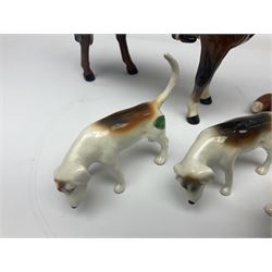 Beswick hunting group, comprising huntswoman on dappled grey horse no 1730, huntsman on bay horse no 1501, two fox figures no 1440 and 1748, and four fox hounds, all with printed marks beneath (8)