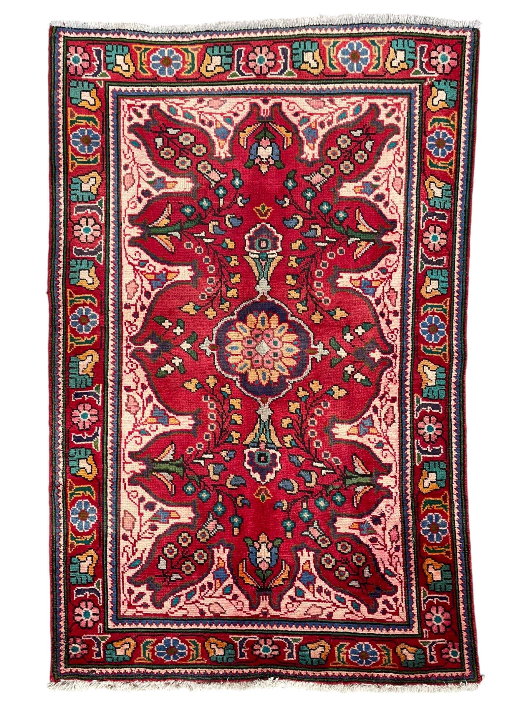 Persian Azerbaijan crimson ground rug, the field decorated with central floral motif and surrounded by trailing floral branches, enclosed within a shaped outer band with further floral decoration, the border with repeating flower heads, geometric guard stripes 